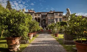 Palazzo Pfanner et son jardin à Lucca, avec des arbres en pot, des statues et une fontaine.