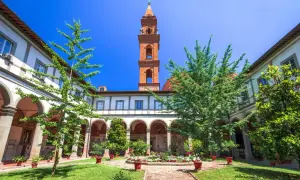 Cour intérieure verdoyante avec fontaine et campanile de Santo Spirito à Florence.